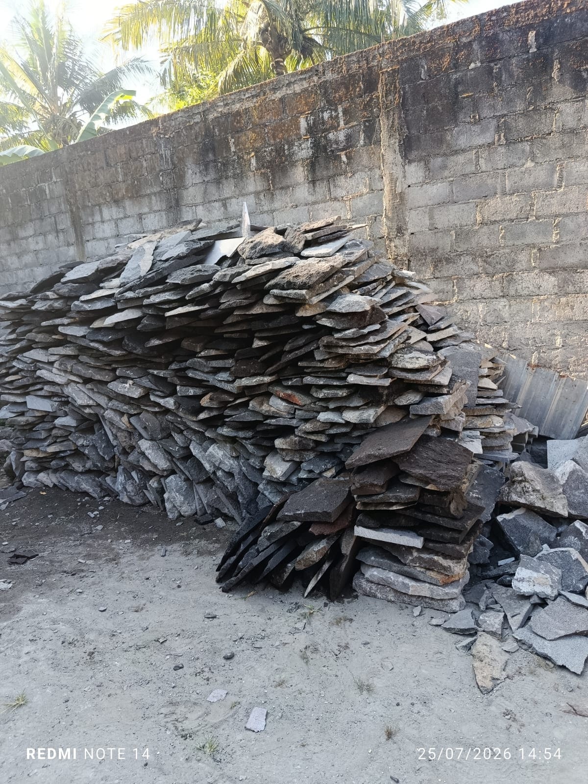 Stacks of irregular thin natural lava stone slabs